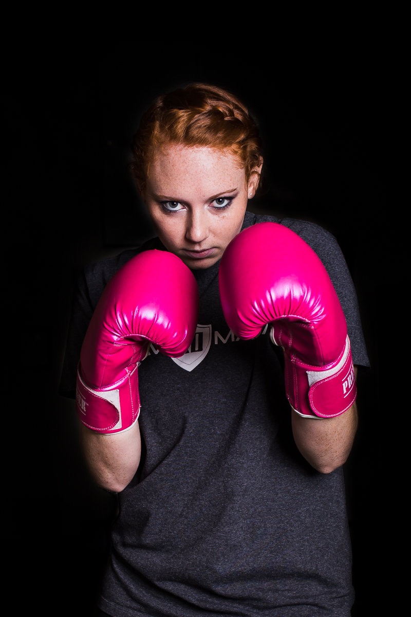 Krav Maga XD instructor, Brooke Evans, in pink boxing gloves. // photo: @byoungforeverphotog