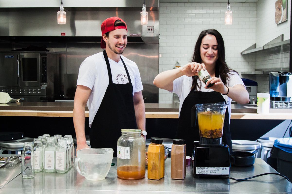 Blending in: Reitler looks on as Golkar adds organic spices to a fresh batch of turmeric almond milk