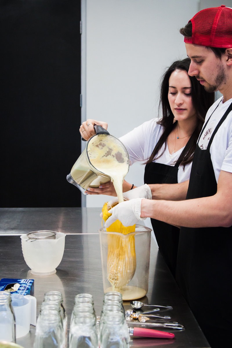 Rawmond Milk's Roxanne Golkar and Bradley Reitler pour raw, sprouted almond milk into a nut bag, in Costa Mesa, CA.