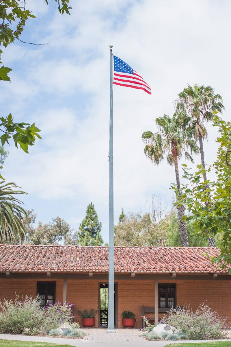 An American Flag Flies Over The Diego Sepulveda Adobe at Estancia Park in Costa Mesa