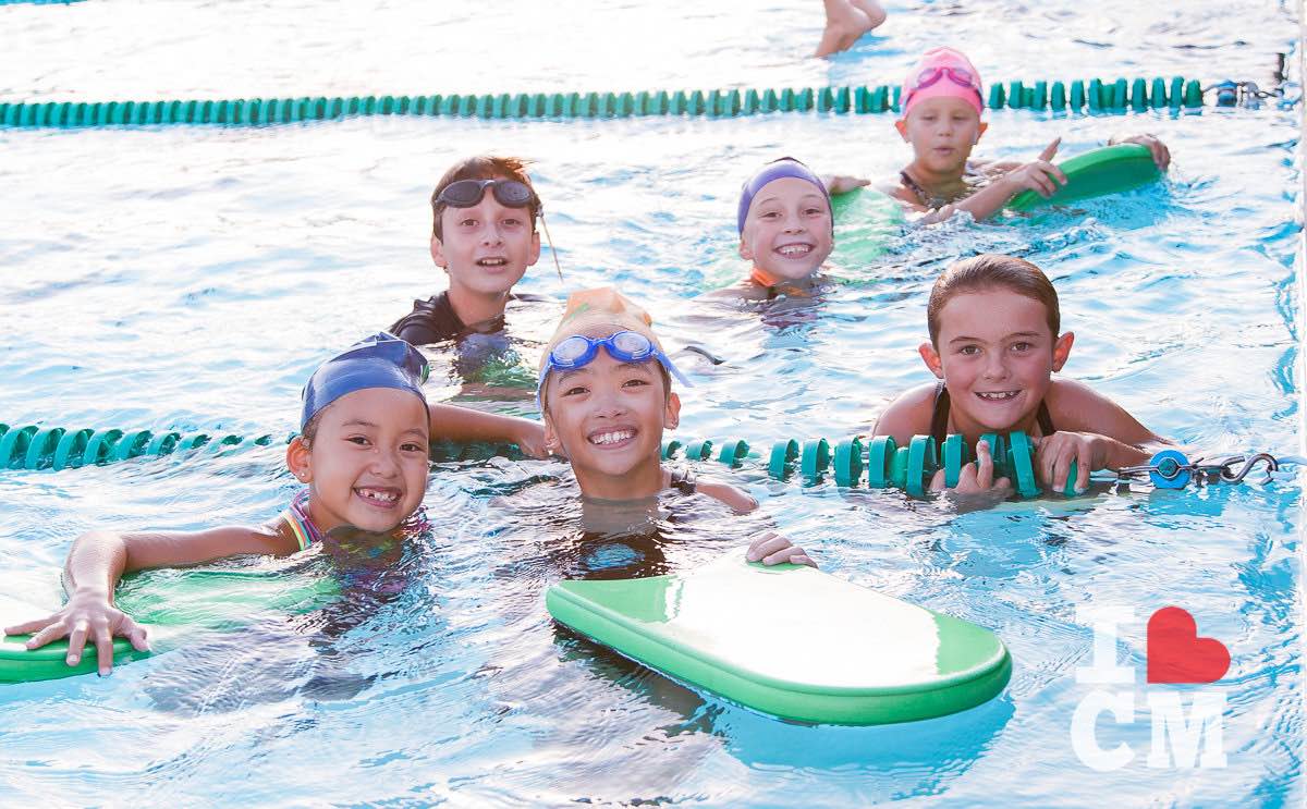 Smiling Kids in the Pool at the Costa Mesa Aquatics Club (CMAC) in Orange County, California