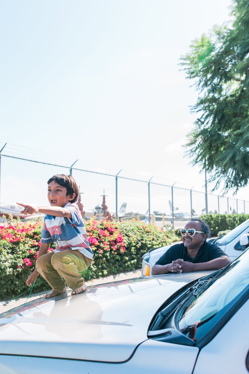 Abu Zubair, with his son, Zarrar, watching planes take off at John Wayne Airport. (Costa Mesa, CA)