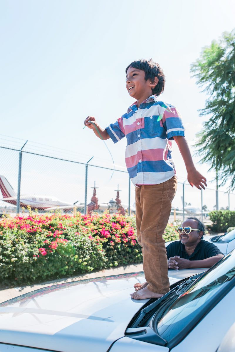 Abu Zubair, with his son, Zarrar, watching planes take off at John Wayne Airport. (Costa Mesa, CA)