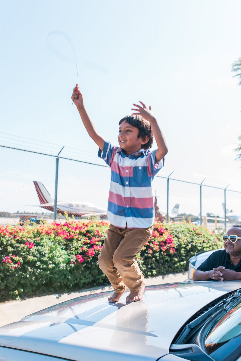 Abu Zubair, with his son, Zarrar, watching planes take off at John Wayne Airport. (Costa Mesa, CA)