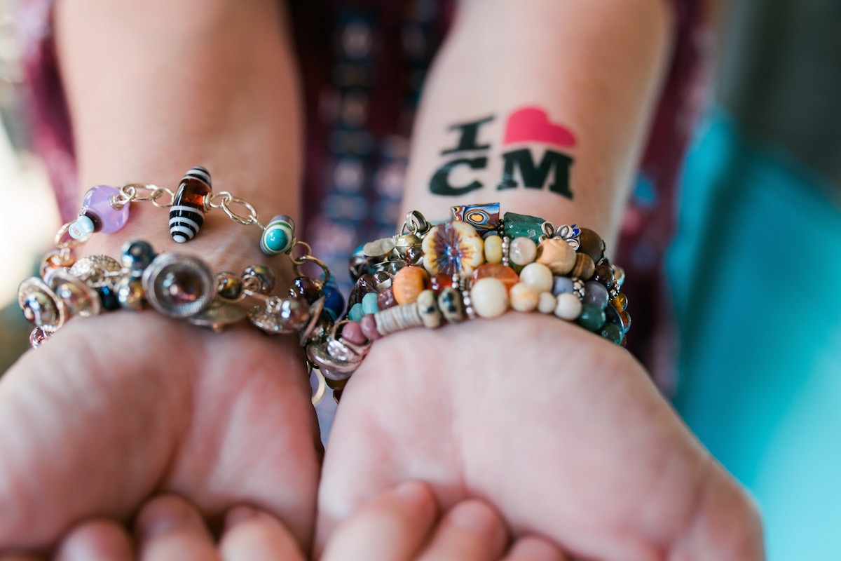 Jewelry-maker Stacey Peterson shows off her beautiful handiwork (along with a little love for Costa Mesa) at The Camp in Orange County.