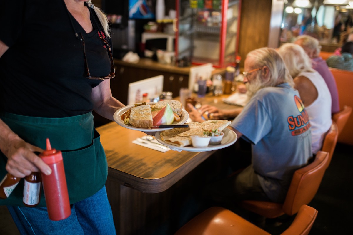 Order Up: Server Serves Breakfast at Dick Church's Restaurant in Costa Mesa, California