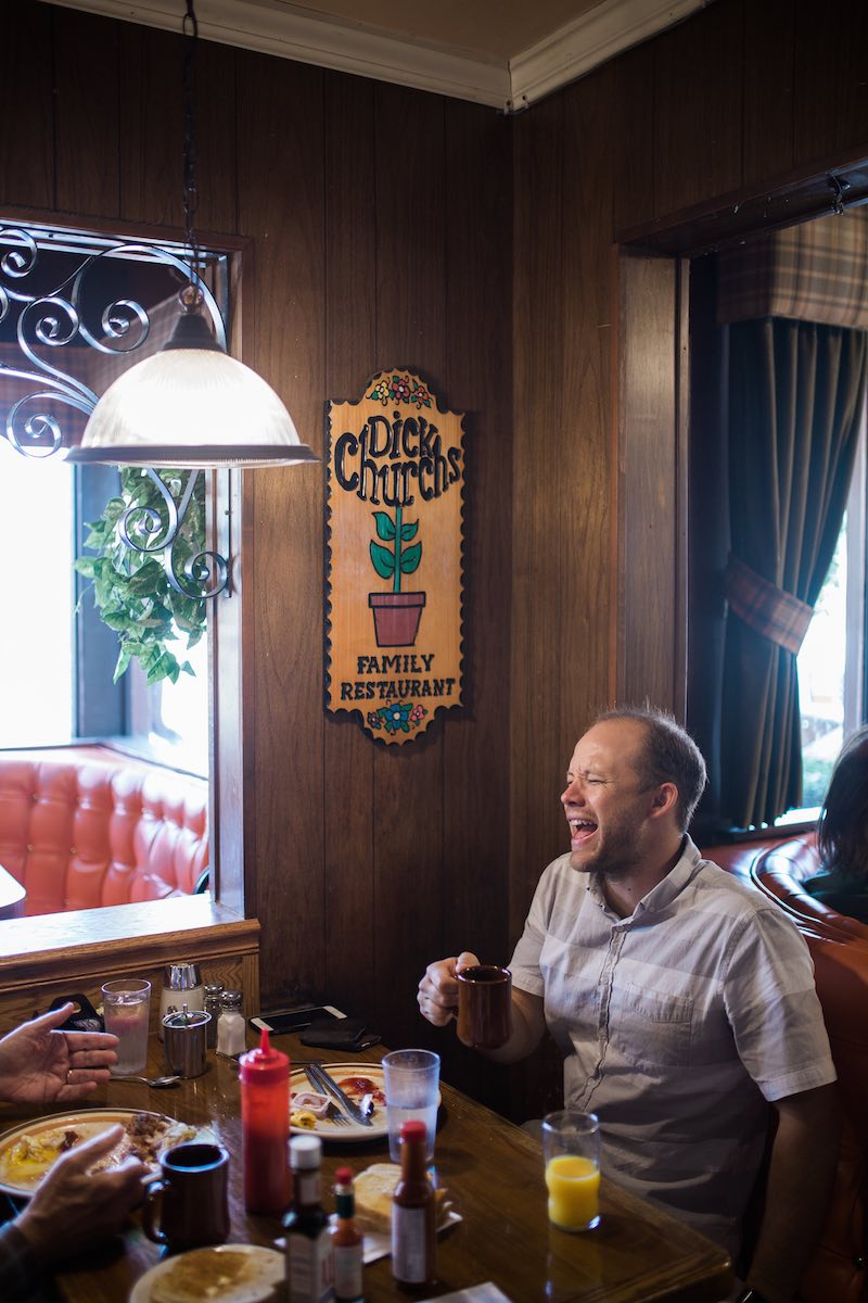 A customer laughs over breakfast and coffee at Dick Church's Restaurant in Eastside Costa Mesa, California