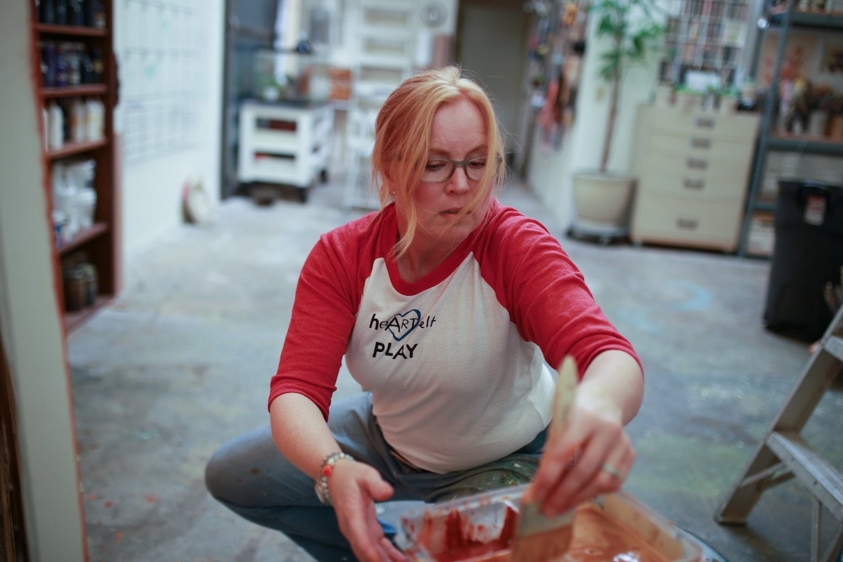 Painter and artist, Gabrielle Carey, selects paint colors at her studio in Costa Mesa, California