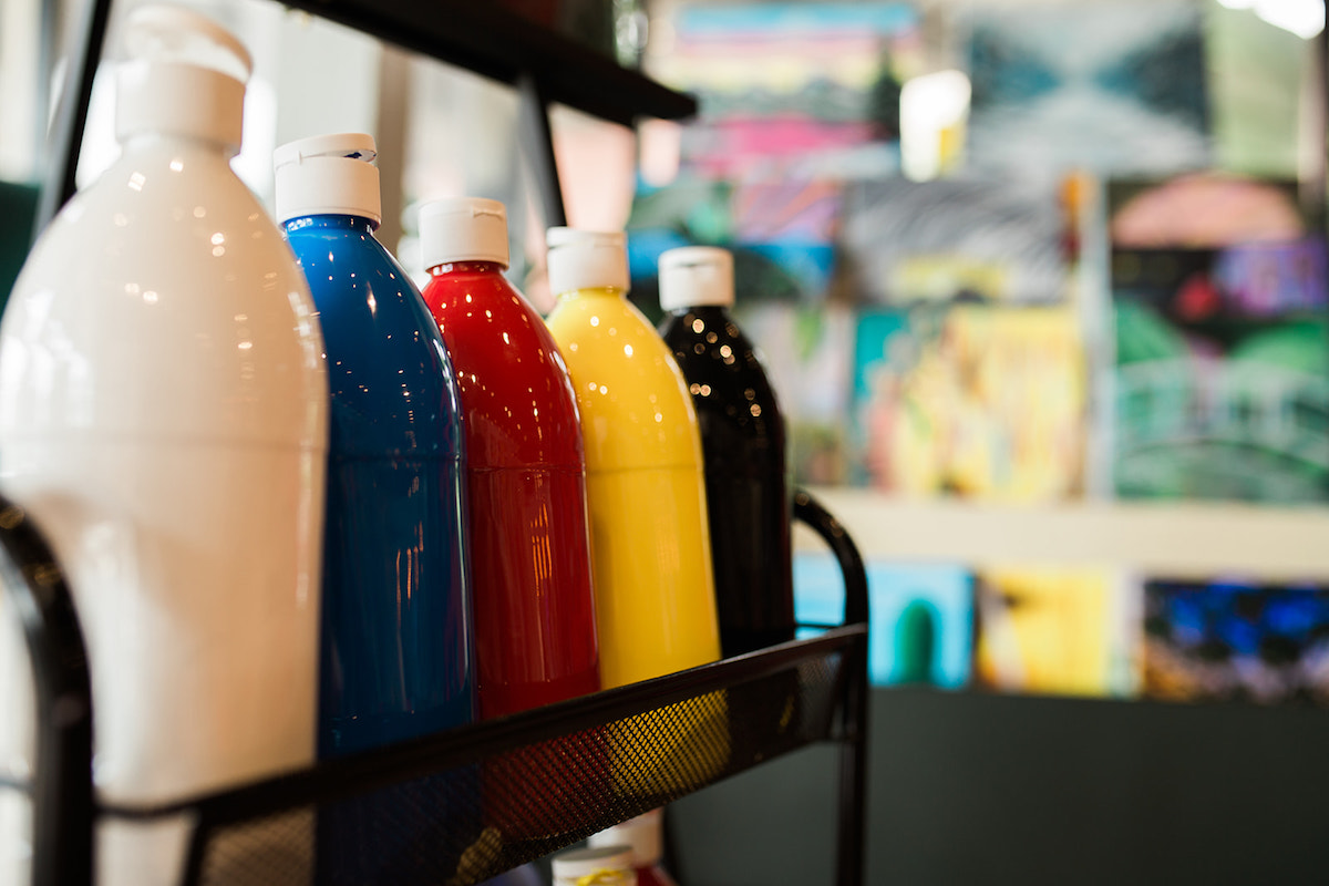 Paint Bottles in White, Blue, Red, Yellow and Black at InspiRED Art Wine in Costa Mesa, California. (photo: Brandy Young)