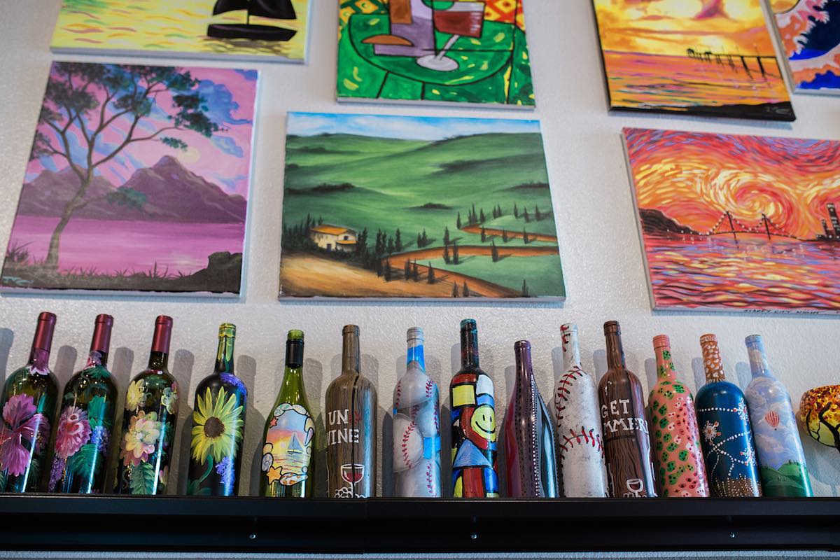 Painted wine bottles and canvases on display at InspiRED Art Wine in Costa Mesa, Orange County, California. (photo: Brandy Young)