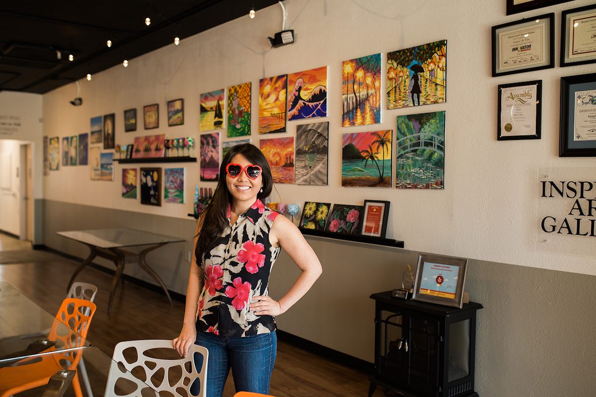 InspiRED Art Wine's Karen Nguyen against her step and repeat at her studio in Costa Mesa, California. (photo: Brandy Young)