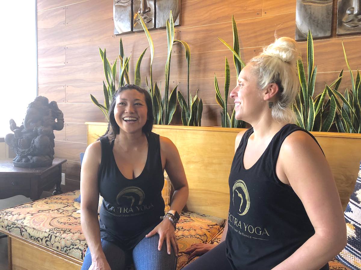 Owner, Aileen Pham, and Studio Manager, Amanda Arias, laugh during an interview at Spectra Yoga in Costa Mesa, California. (photo: Samantha Chagollan)