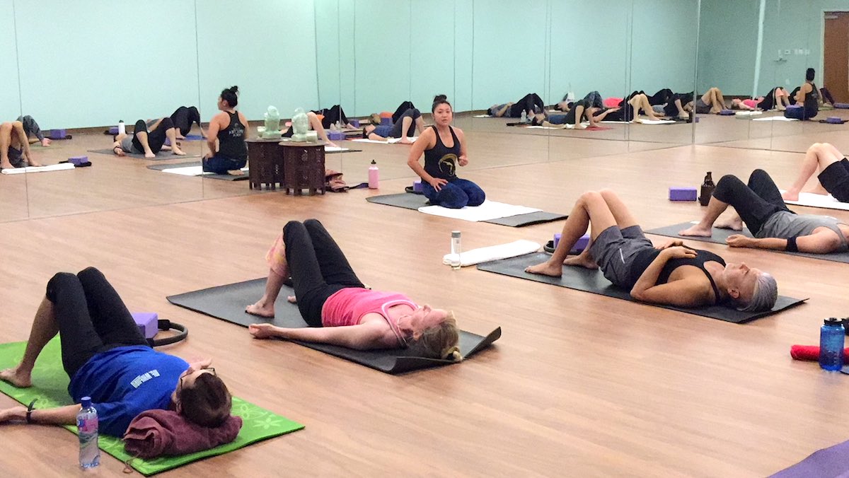 Aileen Pham talks a Yoga Class through poses at Spectra Yoga in Costa Mesa, California. (photo courtesy of Spectra Yoga)
