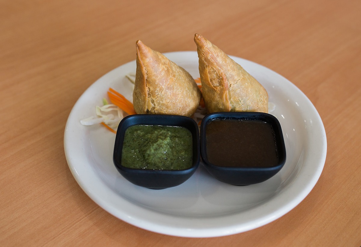 Veggie Samosas with housemade chutney and chimichurri sauce at The India Cafe in Costa Mesa, California. (photo: Brandy Young)
