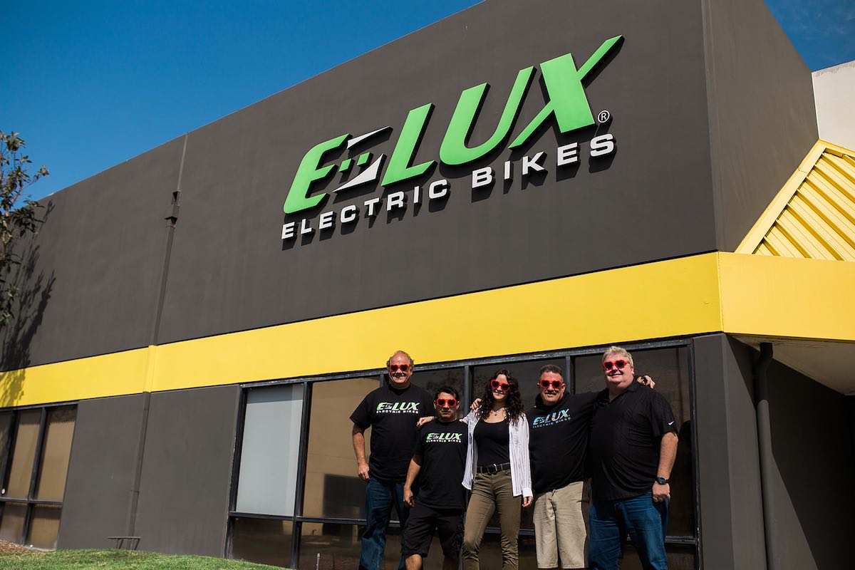 Team of employees in red heart-shaped glasses at E-Lux Bikes in Westside Costa Mesa, Orange County, California. (photo: Brandy Young)