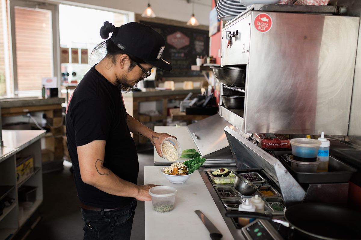 Top Chef, Brina Huskey, prepares a poke bowl in the kitchen of his restaurant / pub, Tackle Box, at SOCO and The OC Mix in Costa Mesa, Orange County, California.