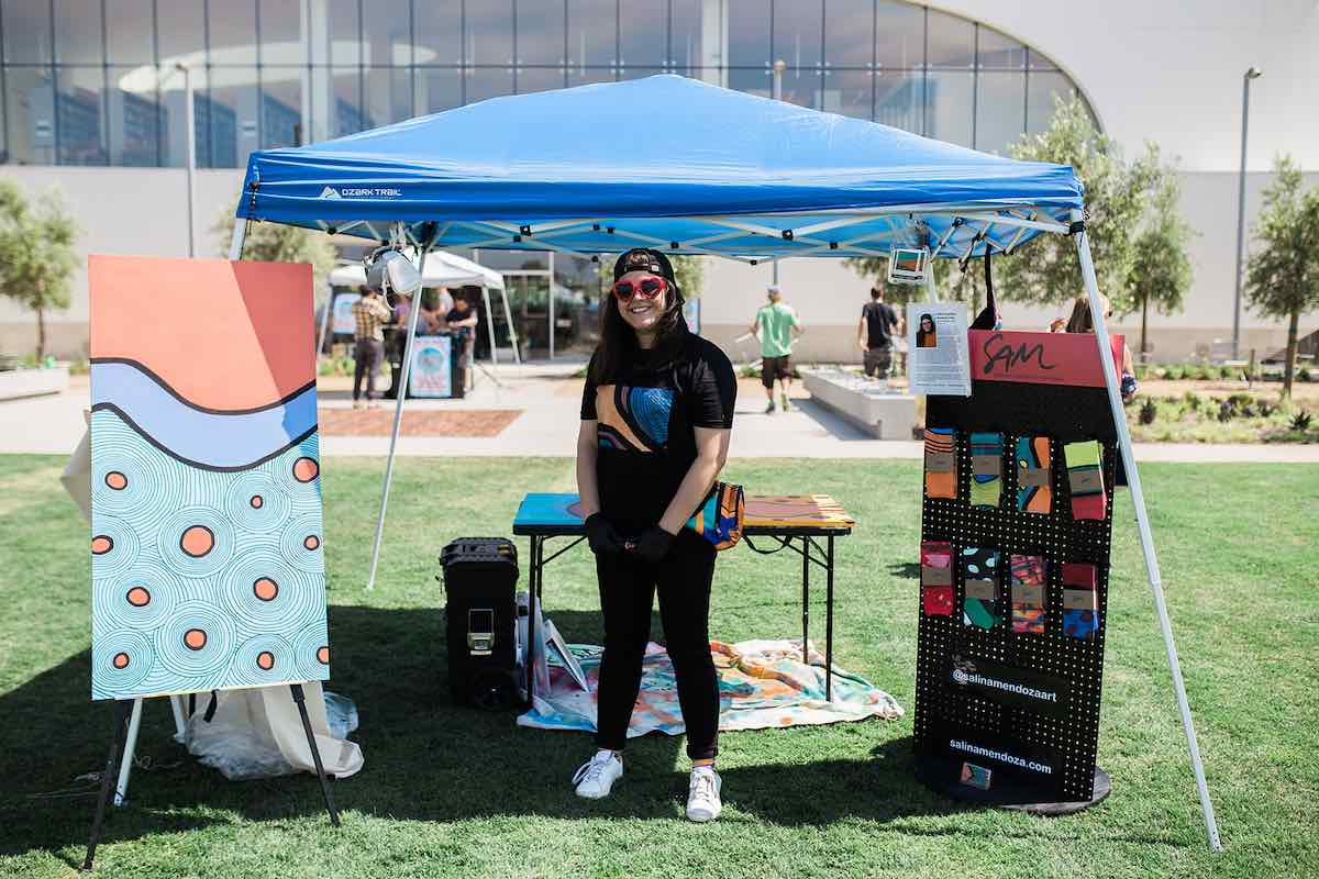 I Heart Costa Mesa: Artist Salina Mendoza shows off some of her artwork, and custom socks, at the Costa Mesa ArtWalk at Lions Park in Costa Mesa, Orange County, California. (photo: Brandy Young)