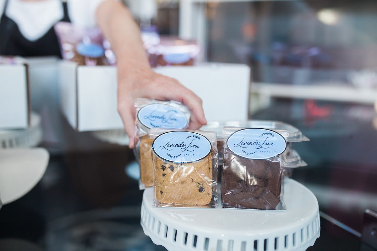 I Heart Costa Mesa: Sarah Butler adjusts a bars and brownies display, at Lavender Lane Baking Co. in Costa Mesa, Orange County, California. (photo: Brandy Young)