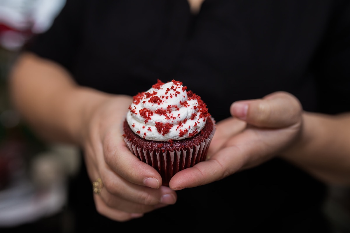 I Heart Costa Mesa: Baker and business owner, Joana Arenas, hold one of her scratch made red velvet cupcakes at Arenas Dream Cakes in Westside Costa Mesa, Orange County, California. (photo: Brandy Young)