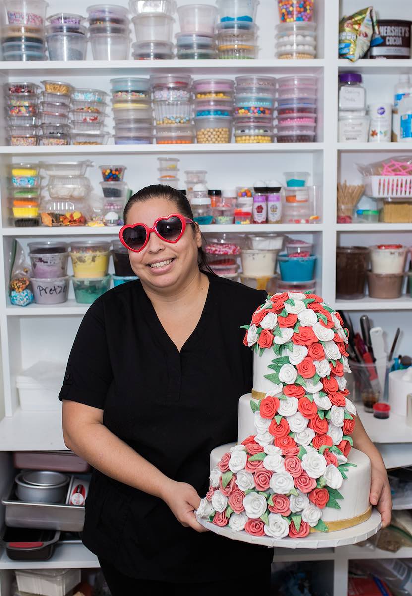 I Heart Costa Mesa: Baker and business owner, Joana Arenas, posed with one of her display cakes and red heart-shaped sunglasses at Arenas Dream Cakes in Westside Costa Mesa, Orange County, California. (photo: Brandy Young)