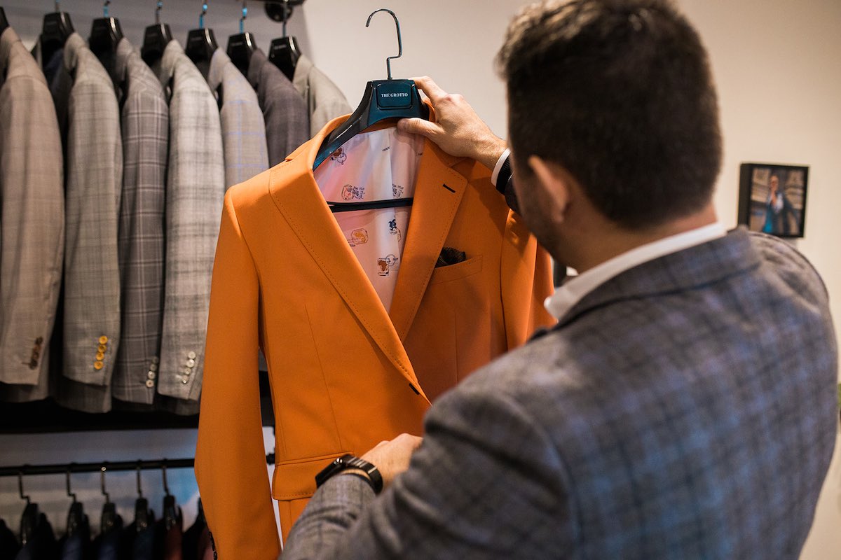 I Heart Costa Mesa: Owner, Matt Scord, Examines a men's suit jacket at The Grotto custom menswear in Westside Costa Mesa, Orange County, California. (photo: Brandy Young)